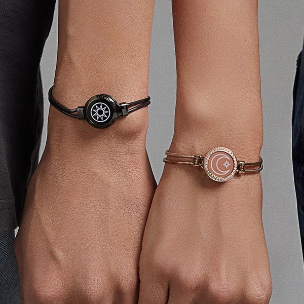 couple showing their totwoo sun and moon connected bracelets