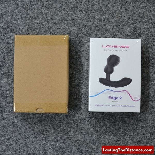 lovense edge 2 in box next to discreet shipping packaging
