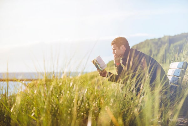 man reading a book as a mental health exercise