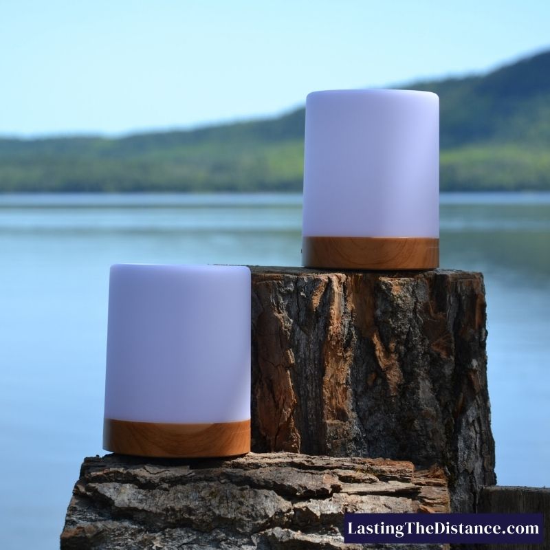 long distance touch lamps by friendlamps sitting on wood in front of a lake